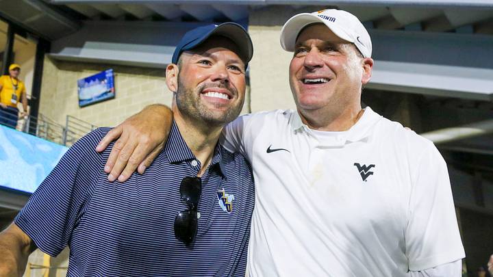 Sep 13, 2025; Morgantown, West Virginia, USA; West Virginia Mountaineers head coach Rich Rodriguez celebrates with West Virginia University athletic director Wren Baker after defeating the Pittsburgh Panthers at Milan Puskar Stadium. Mandatory Credit: Ben Queen-Imagn Images Sep 13, 2025; Morgantown, West Virginia, USA; West Virginia Mountaineers head coach Rich Rodriguez celebrates with West Virginia University athletic director Wren Baker after defeating the Pittsburgh Panthers at Milan Puskar Stadium. Mandatory Credit: Ben Queen-Imagn Images