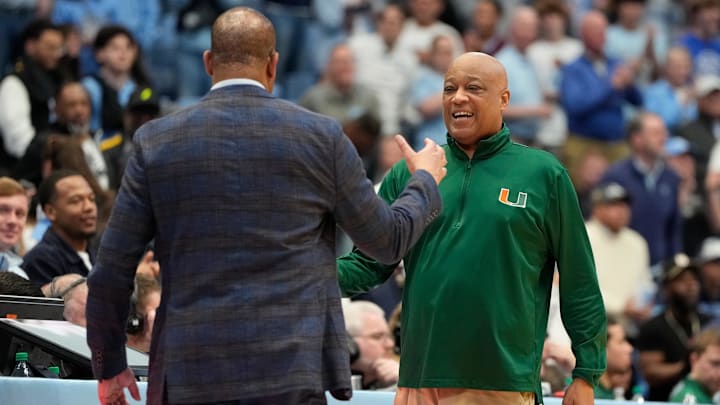 Mar 1, 2025; Chapel Hill, North Carolina, USA;  North Carolina Tar Heels head coach Hubert Davis with Miami (Fl) Hurricanes head coach Bill Courtney at the end of the game at Dean E. Smith Center. Mandatory Credit: Bob Donnan-Imagn Images