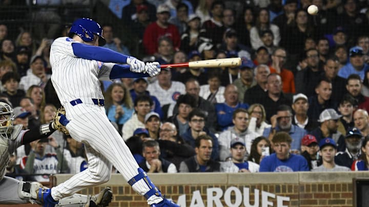 May 12, 2025; Chicago, Illinois, USA;  Chicago Cubs outfielder Kyle Tucker (30) hits an RBI triple against the Miami Marlins during the fifth inning at Wrigley Field.