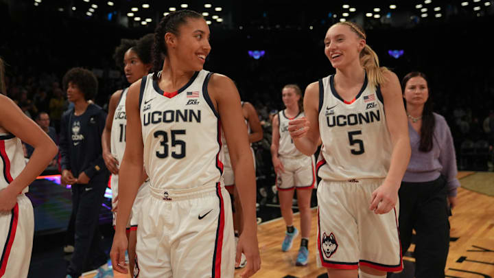 Dec 7, 2024; Brooklyn, New York, USA; Connecticut Huskies guard Azzi Fudd (35) and Connecticut Huskies guard Paige Bueckers (5) celebrate after the game against the Louisville Cardinals at Barclays Center. Mandatory Credit: Lucas Boland-Imagn Images Dec 7, 2024; Brooklyn, New York, USA; Connecticut Huskies guard Azzi Fudd (35) and Connecticut Huskies guard Paige Bueckers (5) celebrate after the game against the Louisville Cardinals at Barclays Center. Mandatory Credit: Lucas Boland-Imagn Images
