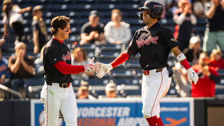 WooSox player Roman Anthony (left) high fives teammate Marcelo Mayer during a Triple-A game at Polar Park on April 23, 2025.