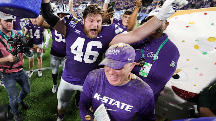 Dec 28, 2023; Orlando, FL, USA;  Kansas State Wildcats head coach Chris Klieman is congratulated by Kansas State Wildcats defensive end Jace Friesen (46) after beating North Carolina State Wolfpack in the Pop-Tarts bowl at Camping World Stadium. Mandatory Credit: Nathan Ray Seebeck-USA TODAY Sports