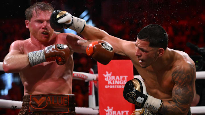 Edgar Berlanga (right) throws a right hand against Saul "Canelo" Alvarez (left).