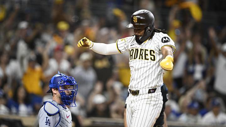 Aug 23, 2025; San Diego, California, USA; San Diego Padres right fielder Fernando Tatis Jr. (23) celebrates as he scores as Los Angeles Dodgers catcher Will Smith (16) looks on during the eighth inning at Petco Park. Mandatory Credit: Denis Poroy-Imagn Images Aug 23, 2025; San Diego, California, USA; San Diego Padres right fielder Fernando Tatis Jr. (23) celebrates as he scores as Los Angeles Dodgers catcher Will Smith (16) looks on during the eighth inning at Petco Park. Mandatory Credit: Denis Poroy-Imagn Images