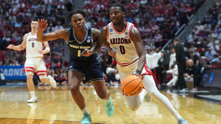 Mar 22, 2026; San Diego, CA, USA; Arizona Wildcats guard Jaden Bradley (0) controls the ball against Utah State Aggies guard Elijah Perryman (1) in the first half during a second round game of the men's 2026 NCAA Tournament at Viejas Arena. Mandatory Credit: Kirby Lee-Imagn Images