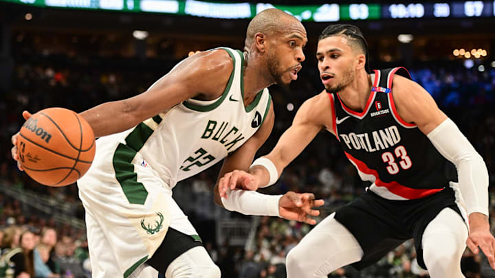 Jan 4, 2025; Milwaukee, Wisconsin, USA; Milwaukee Bucks forward Khris Middleton (22) drives for the basket against Portland Trail Blazers forward Toumani Camara (33) in the third quarter at Fiserv Forum. Mandatory Credit: Benny Sieu-Imagn Images