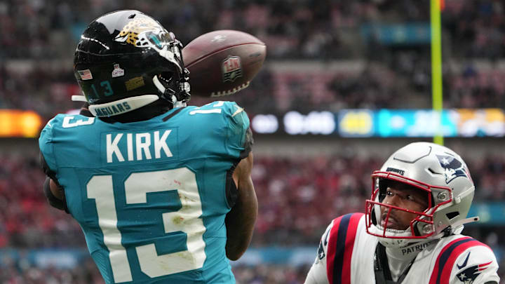 Oct 20, 2024; London, United Kingdom; Jacksonville Jaguars wide receiver Christian Kirk (13) attempts to catch the ball against New England Patriots cornerback Marcus Jones (25) in the second half of an NFL International Series game at Wembley Stadium. Mandatory Credit: Kirby Lee-Imagn Images
