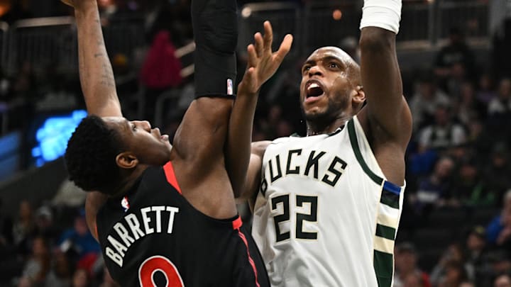 Apr 5, 2024; Milwaukee, Wisconsin, USA; Milwaukee Bucks forward Khris Middleton (22) puts up a shot against Toronto Raptors guard RJ Barrett (9) in the second half at Fiserv Forum. Mandatory Credit: Michael McLoone-Imagn Images