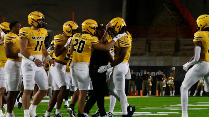 Sept 27, 2025; Columbia, Missouri, USA; Missouri Tigers safety Santana Banner (15, center) celebrates with his teammates and safeties coach (Jacob Yoro) after Banner's interception in a game against UMass at Memorial Stadium.