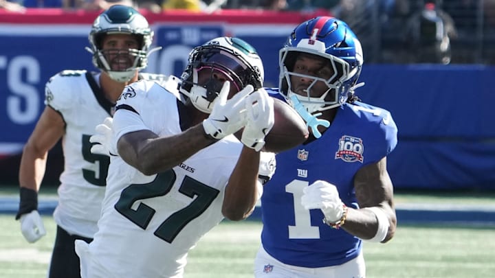 Oct 20, 2024; East Rutherford, New Jersey, USA;  Philadelphia Eagles cornerback Quinyon Mitchell (27) can't hang on to an attempted interception against New York Giants wide receiver Malik Nabers (1) during the first half at MetLife Stadium. 
