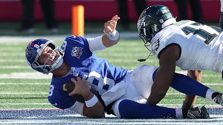 Oct 20, 2024; East Rutherford, New Jersey, USA;  New York Giants quarterback Daniel Jones (8) sacked by Philadelphia Eagles linebacker Nakobe Dean (17) during the second half at MetLife Stadium.  