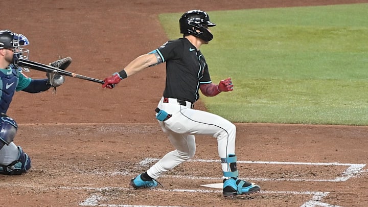 Jun 11, 2025; Phoenix, Arizona, USA;  Arizona Diamondbacks outfielder Corbin Carroll (7) singles in in the sixth inning against the Seattle Mariners at Chase Field. Mandatory Credit: Matt Kartozian-Imagn Images