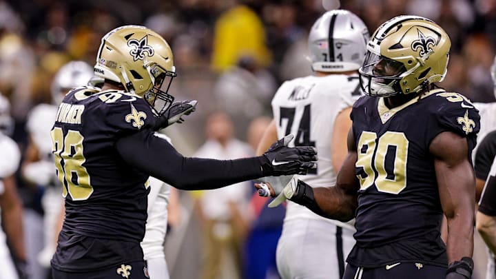 Oct 30, 2022; New Orleans, Louisiana, USA; New Orleans Saints defensive end Payton Turner (98) and New Orleans Saints defensive end Tanoh Kpassagnon (90) react to sacking Las Vegas Raiders quarterback Jarrett Stidham (3) during the second half at Caesars Superdome. Mandatory Credit: Stephen Lew-Imagn Images Oct 30, 2022; New Orleans, Louisiana, USA; New Orleans Saints defensive end Payton Turner (98) and New Orleans Saints defensive end Tanoh Kpassagnon (90) react to sacking Las Vegas Raiders quarterback Jarrett Stidham (3) during the second half at Caesars Superdome. Mandatory Credit: Stephen Lew-Imagn Images