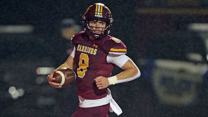 Walsh Jesuit quarterback Keller Moten scores a touchdown during the first half of a Division II regional semifinal football game at Ravenna High School, Friday, Nov. 15, 2024, in Ravenna, Ohio.