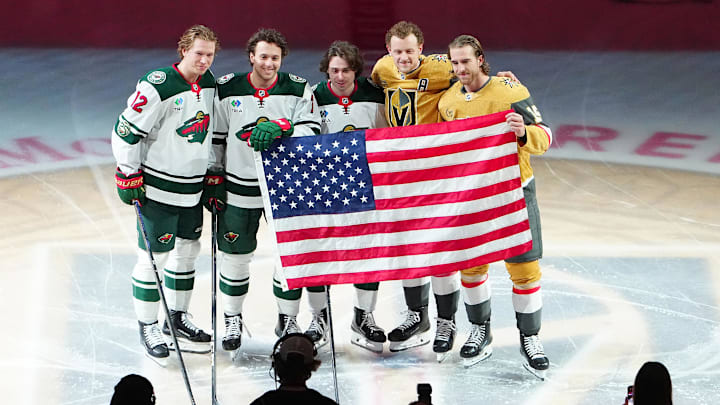 Mar 6, 2026; Las Vegas, Nevada, USA; Minnesota Wild left wing Matt Boldy (12), defenseman Brock Faber (7), defenseman Quinn Hughes (43), Vegas Golden Knights center Jack Eichel (9) and defenseman Noah Hanifin (15) are recognized for their accomplishments during the 2026 Winter Olympics before the start of a game at T-Mobile Arena. Mandatory Credit: Stephen R. Sylvanie-Imagn Images