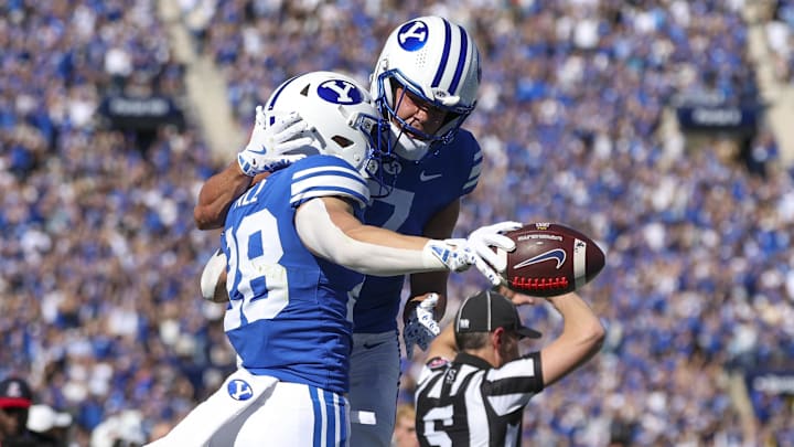 BYU Cougars safety Tanner Wall, left, and Crew Wakley celebrate an interception against the Arizona Wildcats.
