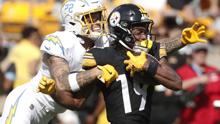 Sep 22, 2024; Pittsburgh, Pennsylvania, USA;  Pittsburgh Steelers wide receiver Calvin Austin III (19) fights of a tackle attempt by Los Angeles Chargers cornerback Elijah Molden (22) to score a fifty-five yard touchdown during the fourth quarter at Acrisure Stadium. Pittsburgh won 20-10. Mandatory Credit: Charles LeClaire-Imagn Images