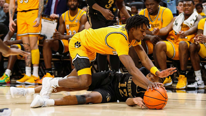 Nov 27, 2024; Columbia, Missouri, USA; Missouri Tigers guard Anthony Robinson II (0) and Lindenwood Lions guard Anias Futrell (12) fight for a loose ball during the second half at Mizzou Arena. Mandatory Credit: Jay Biggerstaff-Imagn Images
