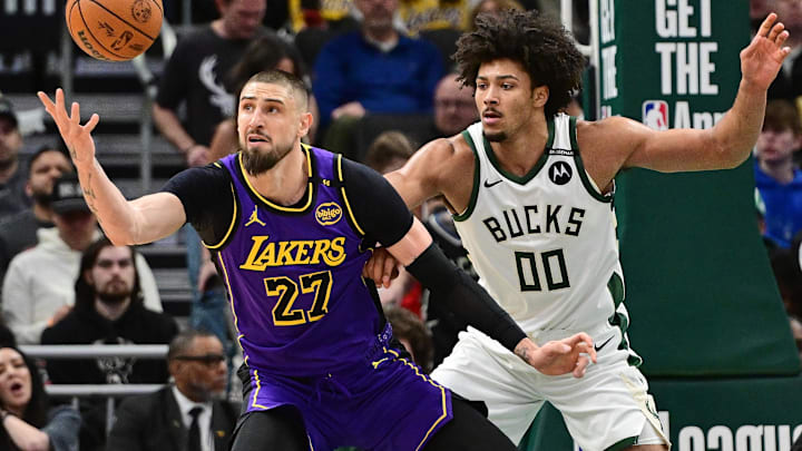 Mar 13, 2025; Milwaukee, Wisconsin, USA; Los Angeles Lakers center Alex Len (27) reaches for the ball against Milwaukee Bucks center Jericho Sims (00) in the second quarter at Fiserv Forum. Mandatory Credit: Benny Sieu-Imagn Images Mar 13, 2025; Milwaukee, Wisconsin, USA; Los Angeles Lakers center Alex Len (27) reaches for the ball against Milwaukee Bucks center Jericho Sims (00) in the second quarter at Fiserv Forum. Mandatory Credit: Benny Sieu-Imagn Images