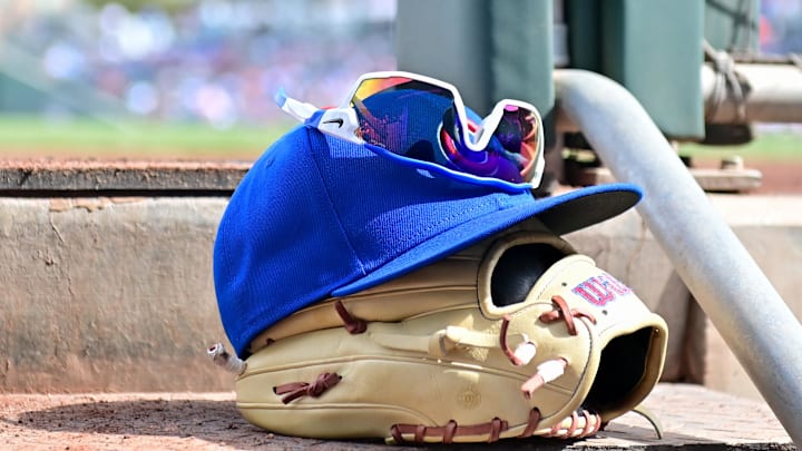 Feb 27, 2024; Mesa, Arizona, USA;  General view of a Chicago Cubs glove, hat and glasses in the first inning against the Cincinnati Reds during a spring training game at Sloan Park. Mandatory Credit: Matt Kartozian-Imagn Images