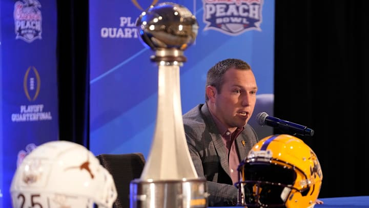 Arizona State head coach Kenny Dillingham responds to a question during a joint news conference with Texas head coach Steve Sarkisian before facing off in the Chick-fil-A Peach Bowl.