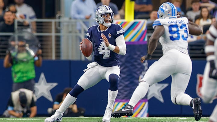 Dallas Cowboys QB Dak Prescott drops to pass with pressure from Detroit Lions DE Josh Paschal.