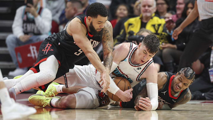 Jan 13, 2025; Houston, Texas, USA; Memphis Grizzlies forward Jake LaRavia (3) attempts to control the ball away from Houston Rockets guard Fred VanVleet (5) and guard Jalen Green (4) during the second half at Toyota Center. Mandatory Credit: Troy Taormina-Imagn Images