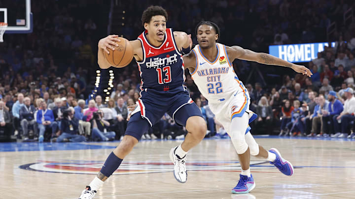 Feb 23, 2024; Oklahoma City, Oklahoma, USA; Washington Wizards guard Jordan Poole (13) moves the ball around Oklahoma City Thunder guard Cason Wallace (22) during the second quarter at Paycom Center. Mandatory Credit: Alonzo Adams-Imagn Images