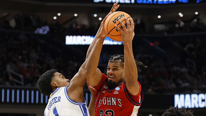 Mar 27, 2026; Washington, DC, USA; St. John's basketball forward Bryce Hopkins (23) attempts to shoot the ball over Duke Blue Devils guard Caleb Foster (1) in the first half during a Sweet Sixteen game of the East Regional of the men's 2026 NCAA Tournament at Capital One Arena. 