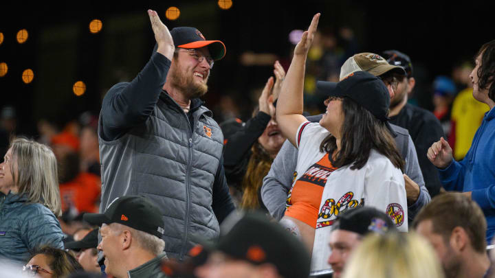 Apr 26, 2024; Baltimore, Maryland, USA; Baltimore Orioles fans celebrate at Oriole Park at Camden Yards. 