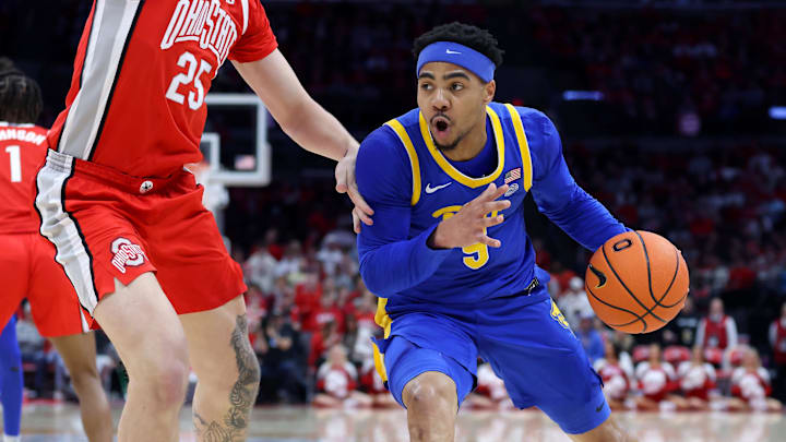 Nov 29, 2024; Columbus, Ohio, USA; Pittsburgh Panthers guard Ishmael Leggett (5) drives to the rim as Ohio State Buckeyes center Austin Parks (25) defends during the first half at Value City Arena. Mandatory Credit: Joseph Maiorana-Imagn Images