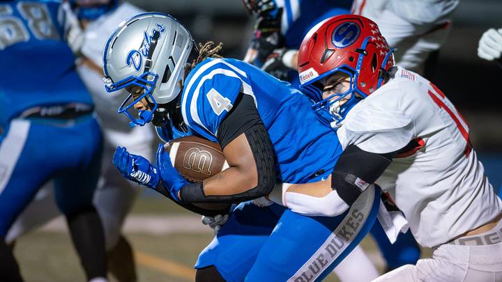 Whitefish Bay running back Kaden Kelly (4) drags Slinger defensive back Cole Lighthizer (12) on a run in a game Friday, September 18, 2026, at Lubar Stadium in Whitefish Bay, Wisconsin. Whitefish Bay won 35-14. Whitefish Bay running back Kaden Kelly (4) drags Slinger defensive back Cole Lighthizer (12) on a run in a game Friday, September 18, 2026, at Lubar Stadium in Whitefish Bay, Wisconsin. Whitefish Bay won 35-14.