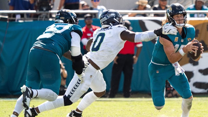 Seattle Seahawks DeMarcus Lawrence (0) gets a hand one Jacksonville Jaguars quarterback Trevor Lawrence (16) during the third quarter in an NFL football game at EverBank Stadium, Sunday, Oct. 12, 2025, in Jacksonville, Fla. [Doug Engle/Florida Times-Union]