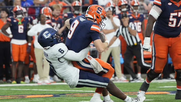 Sep 6, 2025; Syracuse, New York, USA; UConn Huskies linebacker Bryun Parham (6) sacks Syracuse Orange quarterback Steve Angeli (9) during the second half at JMA Wireless Dome. Mandatory Credit: Gregory Fisher-Imagn Images