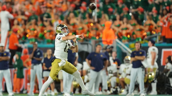 Aug 31, 2025; Miami Gardens, Florida, USA; Notre Dame Fighting Irish quarterback CJ Carr (13) drops back to pass against the Miami Hurricanes during the first quarter at Hard Rock Stadium. Mandatory Credit: Sam Navarro-Imagn Images