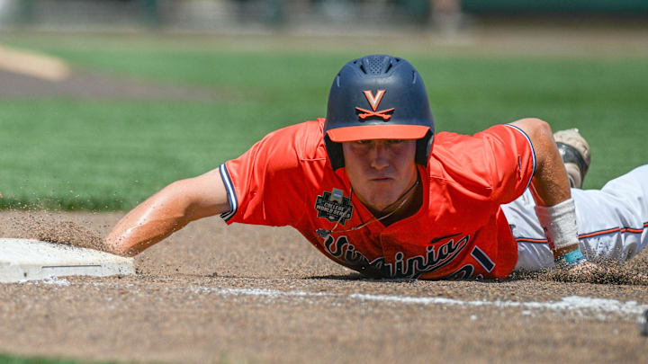 Jun 14, 2024: Virginia Cavaliers third baseman Eric Becker (21) slides back into first base against the North Carolina Tar Heels during the fourth inning at Charles Schwab Filed Omaha. Jun 14, 2024: Virginia Cavaliers third baseman Eric Becker (21) slides back into first base against the North Carolina Tar Heels during the fourth inning at Charles Schwab Filed Omaha.