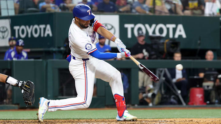 Jul 2, 2024; Arlington, Texas, USA; Texas Rangers third baseman Jonathan Ornelas (21) hits an RBI double during the sixth inning against the San Diego Padres at Globe Life Field. 
