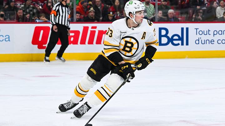 Mar 17, 2026; Montreal, Quebec, CAN; Boston Bruins defenseman Charlie McAvoy (73) plays the puck against the Montreal Canadiens during the second period at Bell Centre. Mandatory Credit: David Kirouac-Imagn Images