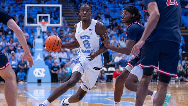 Nov 11, 2025; Chapel Hill, North Carolina, USA; North Carolina Tar Heels forward Caleb Wilson (8) drives past Radford Highlanders guard Jr. Dennis Parker (11) during the second half at Dean E. Smith Center. Mandatory Credit: Scott Kinser-Imagn Images