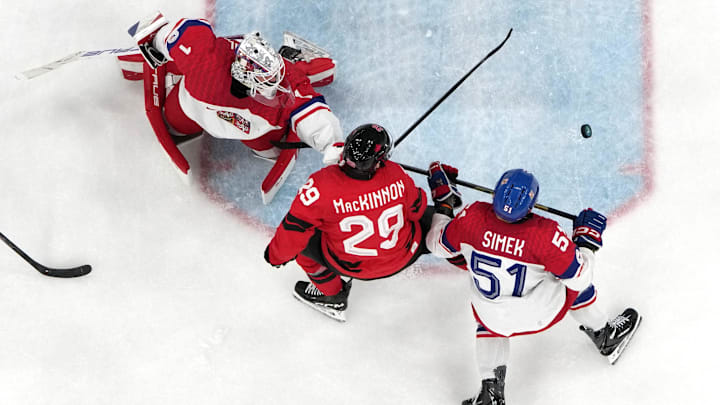 [US, Mexico & Canada customers only] Feb 18, 2026; Milan, Italy; Nathan MacKinnon of Canada in action with Radim Simek and Lukas Dostal of Czech Republic in a men's ice hockey quarterfinal during the Milano Cortina 2026 Olympic Winter Games at Milano Santagiulia Ice Hockey Arena. Mandatory Credit: Mike Segar/Reuters via Imagn Images