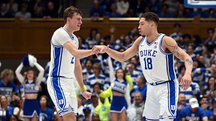 Mar 3, 2025; Durham, North Carolina, USA; Duke Blue Devils forward Mason Gillis (18) is greeted by teammate Cooper Flagg (2) after hitting a three-point shot during the second half against the Wake Forest Demon Deacons at Cameron Indoor Stadium.  The Blue Devils won 93-60. Mandatory Credit: Rob Kinnan-Imagn Images