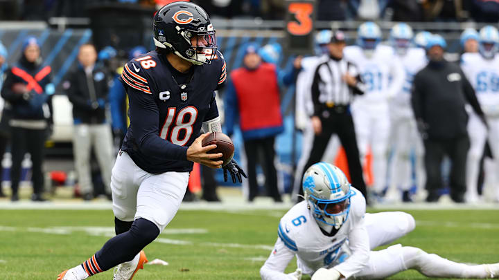 Caleb Williams rolls away from the Lions while looking for a receiver in their game at Soldier Field last year.