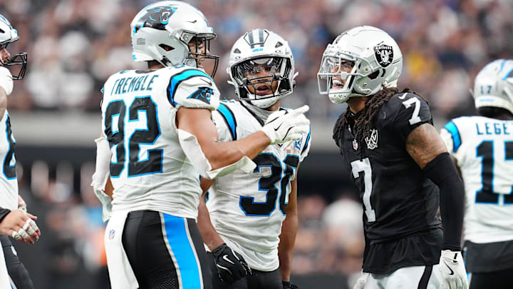 Sep 22, 2024; Paradise, Nevada, USA; Las Vegas Raiders safety Tre'von Moehrig (7) has words with Carolina Panthers tight end Tommy Tremble (82) and Las Vegas Raiders cornerback Darnay Holmes (30) during the fourth quarter at Allegiant Stadium. Mandatory Credit: Stephen R. Sylvanie-Imagn Images