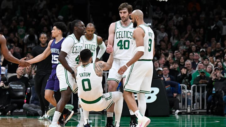 Apr 11, 2025; Boston, Massachusetts, USA; Boston Celtics guard Jrue Holiday (4) and .center Luke Kornet (40) help forward Jayson Tatum (0) to his feet during the second half against the Charlotte Hornets at TD Garden. Mandatory Credit: Eric Canha-Imagn Images