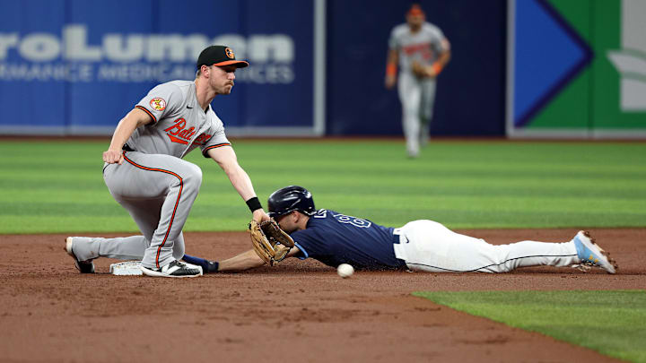 Jun 10, 2024; St. Petersburg, Florida, USA; Tampa Bay Rays second base Brandon Lowe (8) slides safe into second base as Baltimore Orioles third base Jordan Westburg (11) attempted to tag him out during the first inning at Tropicana Field. Mandatory Credit: Kim Klement Neitzel-Imagn Images