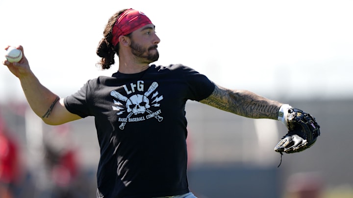 Cincinnati Reds infielder Jonathan India practices outfield throws during spring training workouts.