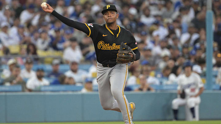 Pittsburgh Pirates third baseman Ke'Bryan Hayes (13) throws out Los Angeles Dodgers shortstop Miguel Rojas (11) at first in the third inning at Dodger Stadium. 