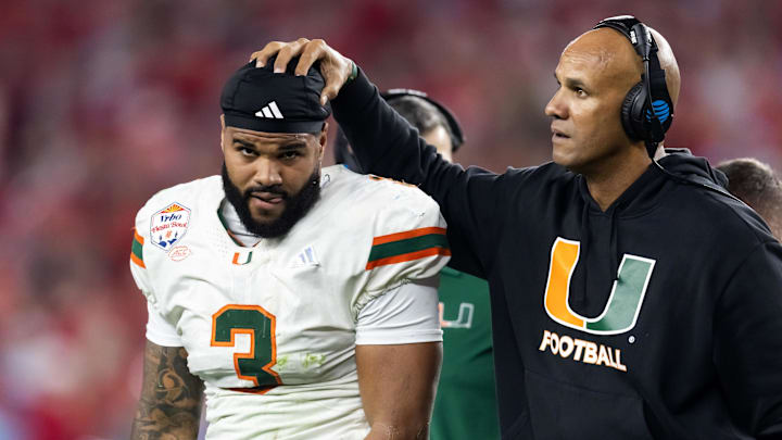 Jan 8, 2026; Glendale, AZ, USA; Miami Hurricanes defensive line coach Jason Taylor with defensive lineman Akheem Mesidor (3) against the Mississippi Rebels during the 2026 Fiesta Bowl and semifinal game of the College Football Playoff at State Farm Stadium. Mandatory Credit: Mark J. Rebilas-Imagn Images Jan 8, 2026; Glendale, AZ, USA; Miami Hurricanes defensive line coach Jason Taylor with defensive lineman Akheem Mesidor (3) against the Mississippi Rebels during the 2026 Fiesta Bowl and semifinal game of the College Football Playoff at State Farm Stadium. Mandatory Credit: Mark J. Rebilas-Imagn Images