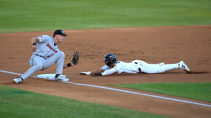 Augusta GreenJacket infielder Tate Southisene (7) slides into third base as Fayetteville infielder Xavier Neyens (9) defends during opening day of the Augusta GreenJackets at SRP Park in North Augusta, S.C., on Tuesday, April 14, 2026. The GreenJackets beat Fayetteville 4-2. Mandatory Credit: Katie Goodale - Augusta Chronicle/USA TODAY NETWORK