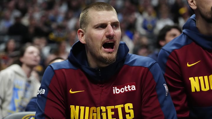 Mar 15, 2025; Denver, Colorado, USA; Denver Nuggets center Nikola Jokic (15) reacts from the bench in the second quarter against the Washington Wizards at Ball Arena. Mandatory Credit: Ron Chenoy-Imagn Images